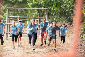 Team running on boot camp obstacle course