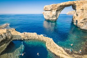 Gozo Island Malta, famous Azure Window with people swimming in it.