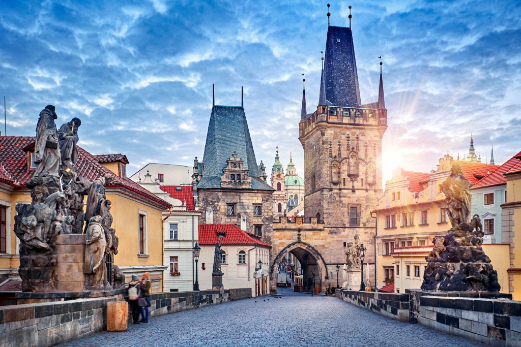 Sunrise on Charles bridge in Prague Czech Republic picturesque landscape morning old Europe with vintage architecture and historical landmark.