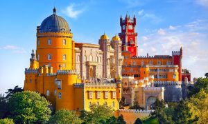 Palace of Pena in Sintra. Lisbon, Portugal. Famous landmark. Summer morning landscape with blue sky.