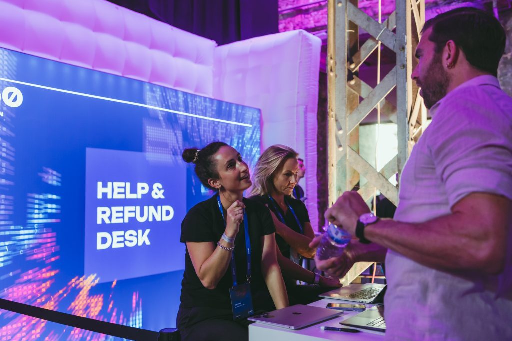 Two woman at hospitality desk, guets managament at conference.