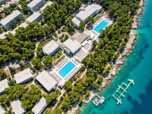Luftaufnahme eines Resorts mit zwei Pools inmitten grüner Landschaft in Kroatien